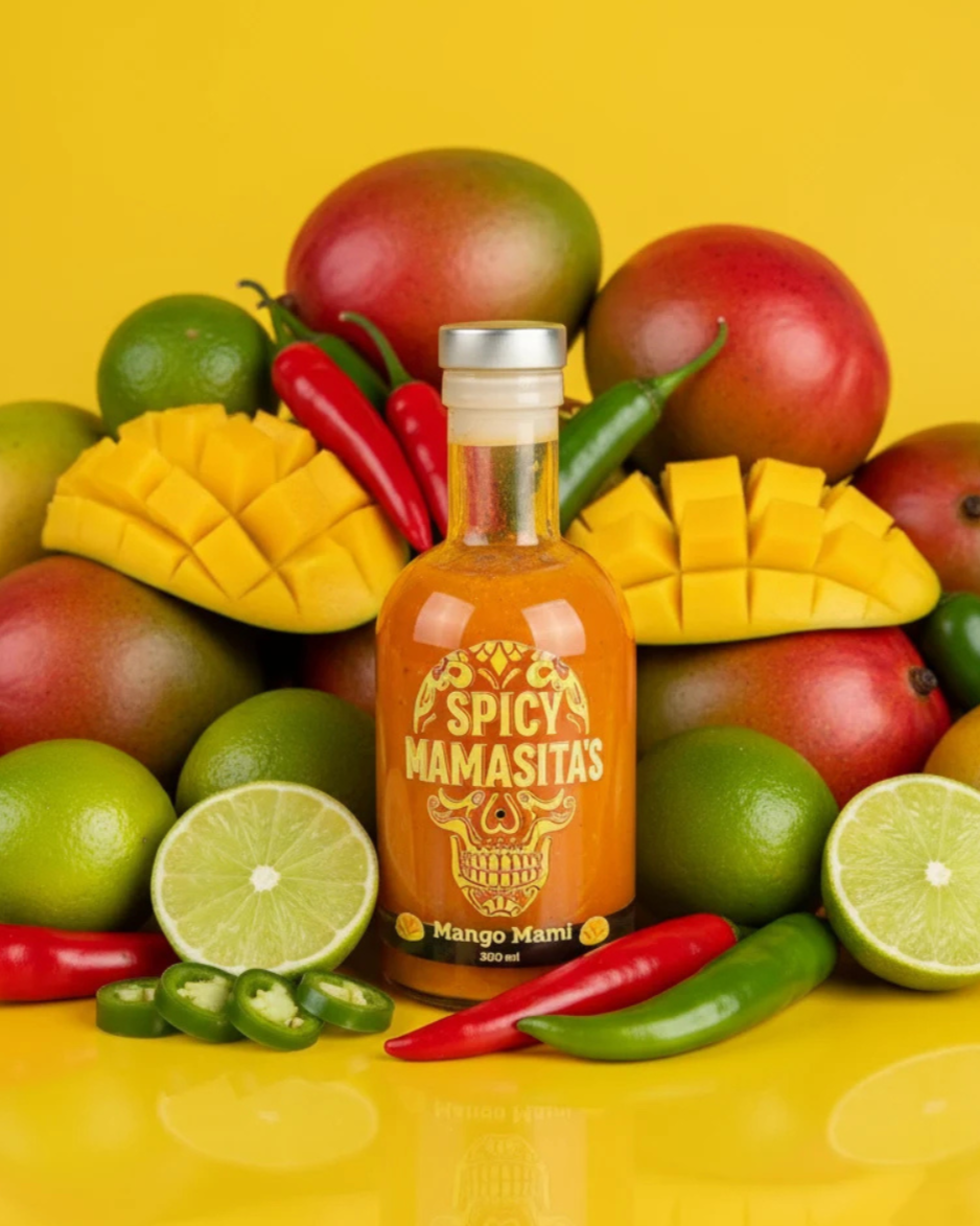 Spicy Mango Mami Hot Sauce bottle from My Store with bright orange label and imagery of mangoes and chili peppers.