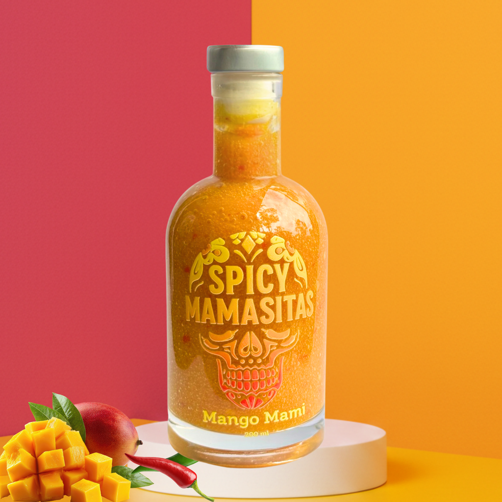 Bottle of Spicy Mamasitas Mango Mami sauce with a colorful background