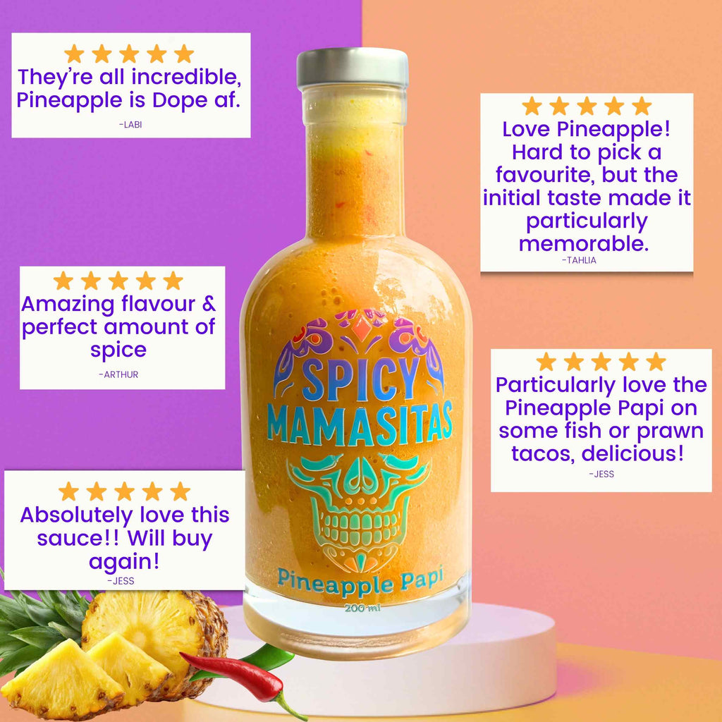 Close-up of Pineapple Papi Hot Sauce bottle with fresh pineapples and spicy peppers, highlighting the vibrant, tropical flavor profile.