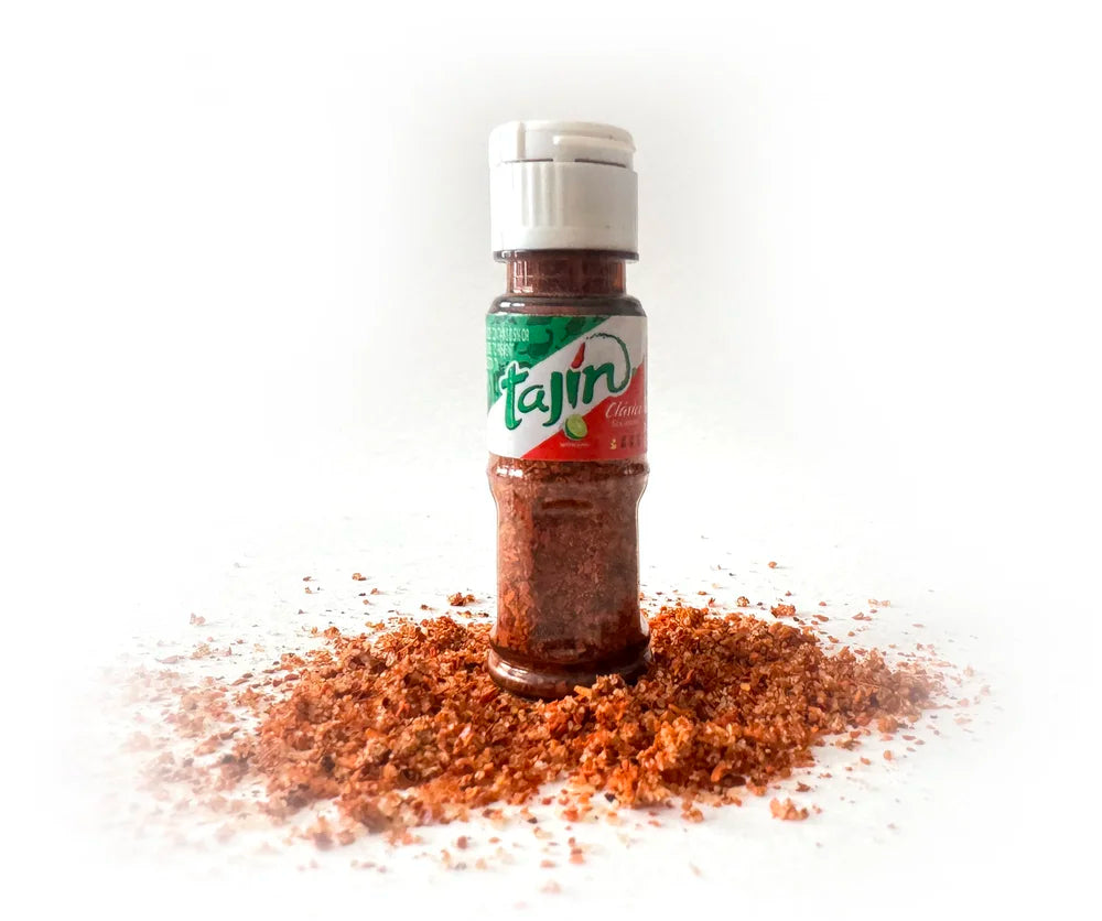 Mini 10g bottle of Tajín seasoning from My Store, showing the iconic orange chili-lime spice blend in a small container.