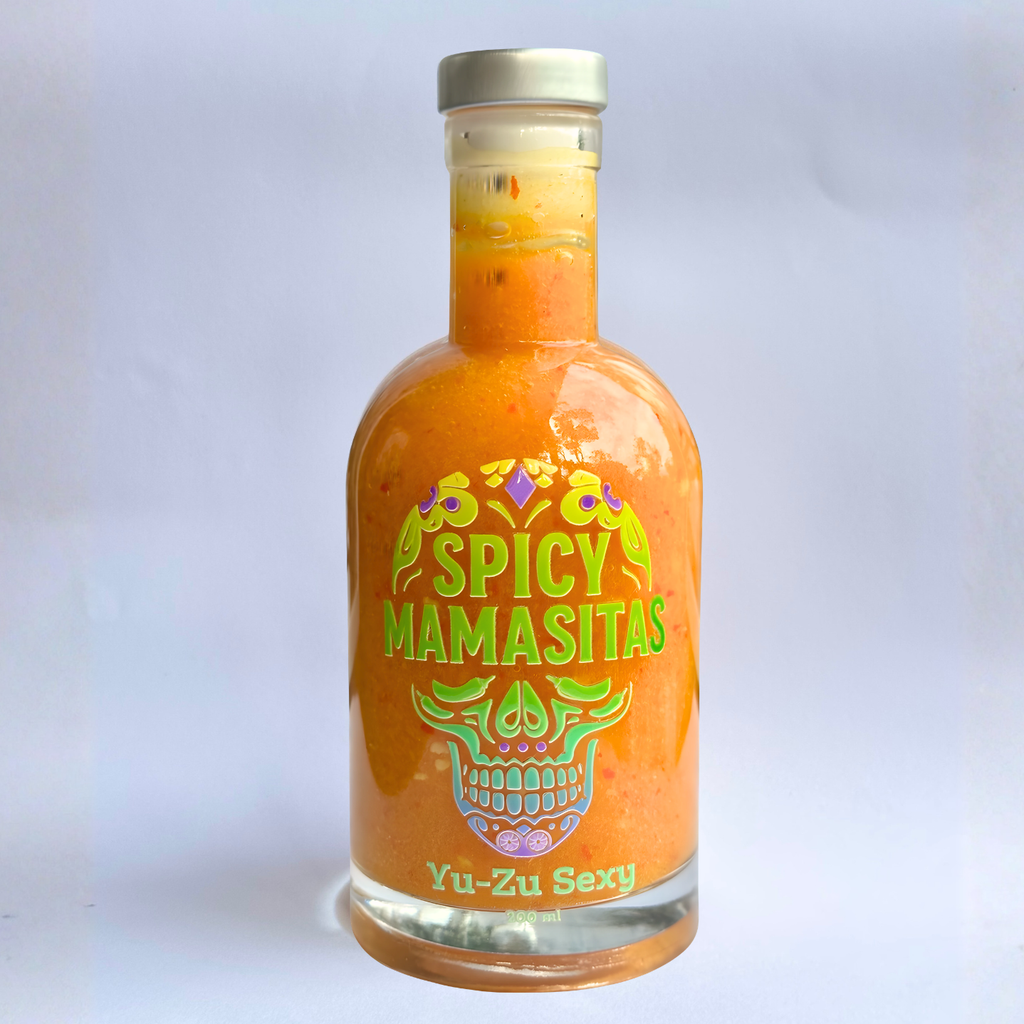 Yuzu hot sauce in a white square bottle, spicy condiment from YuZu brand, with vibrant citrus flavor and bold appearance.